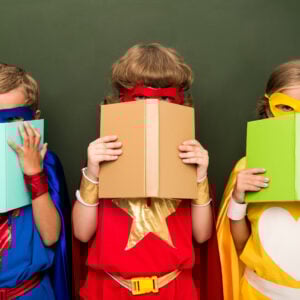little superheroes in costumes holding books chal 2023 11 27 05 31 13 utc
