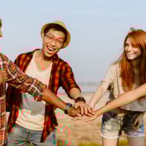 young multiracial friends holding hands and laughi 2023 11 27 05 02 03 utc