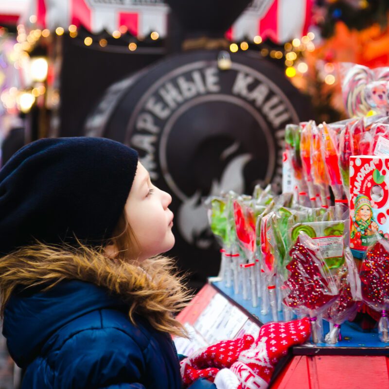 a cute little girl looks at the christmas lollipop 2023 11 27 05 12 50 utc