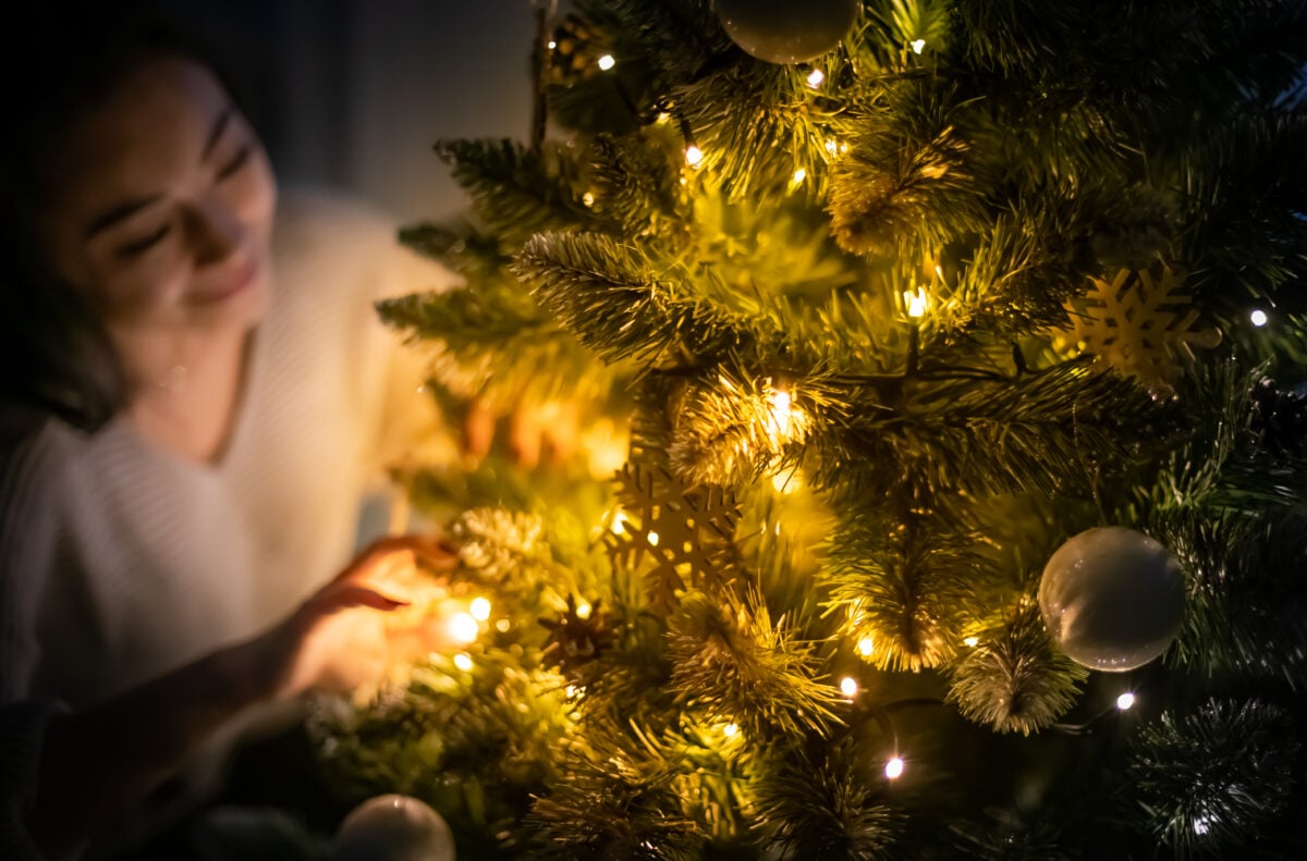 beautiful asian woman decorating christmas tree in 2024 10 31 04 29 12 utc