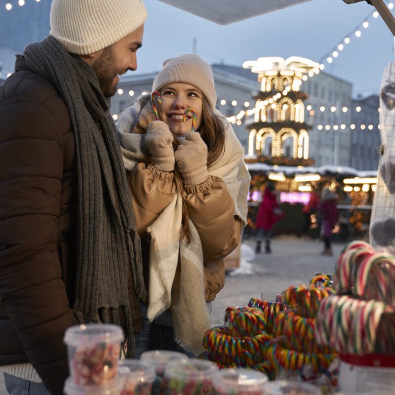 caucasian couple buying candies on christmas marke 2023 12 13 23 26 52 utc 1