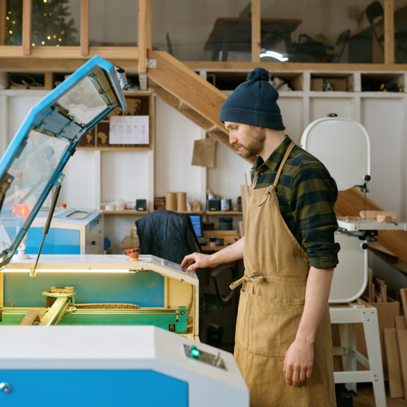 man carpenter operating cnc laser machine in autom 2023 11 27 04 56 42 utc