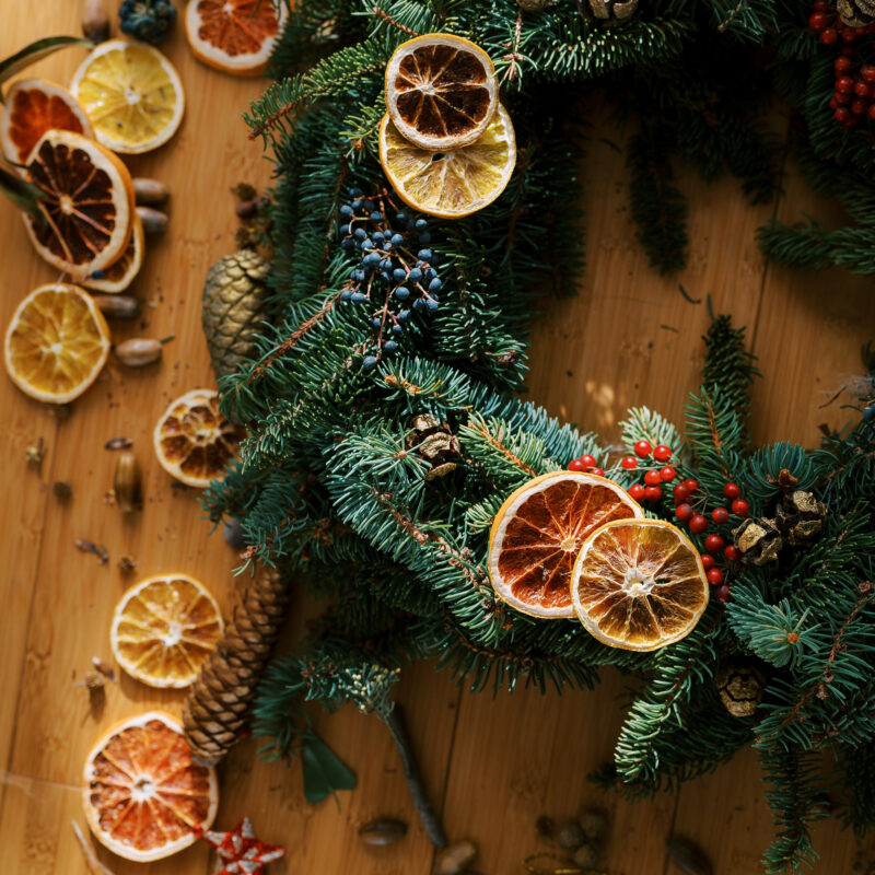 How to Make a Beautiful Christmas Wreath for the Holidays 2 pieces of dried oranges and fir cones lie near a c 2023 11 27 05 30 26 utc