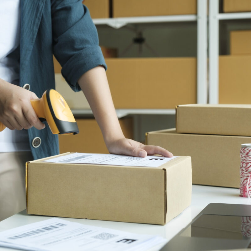 young entrepreneur scanning online order box 2023 11 27 04 57 24 utc