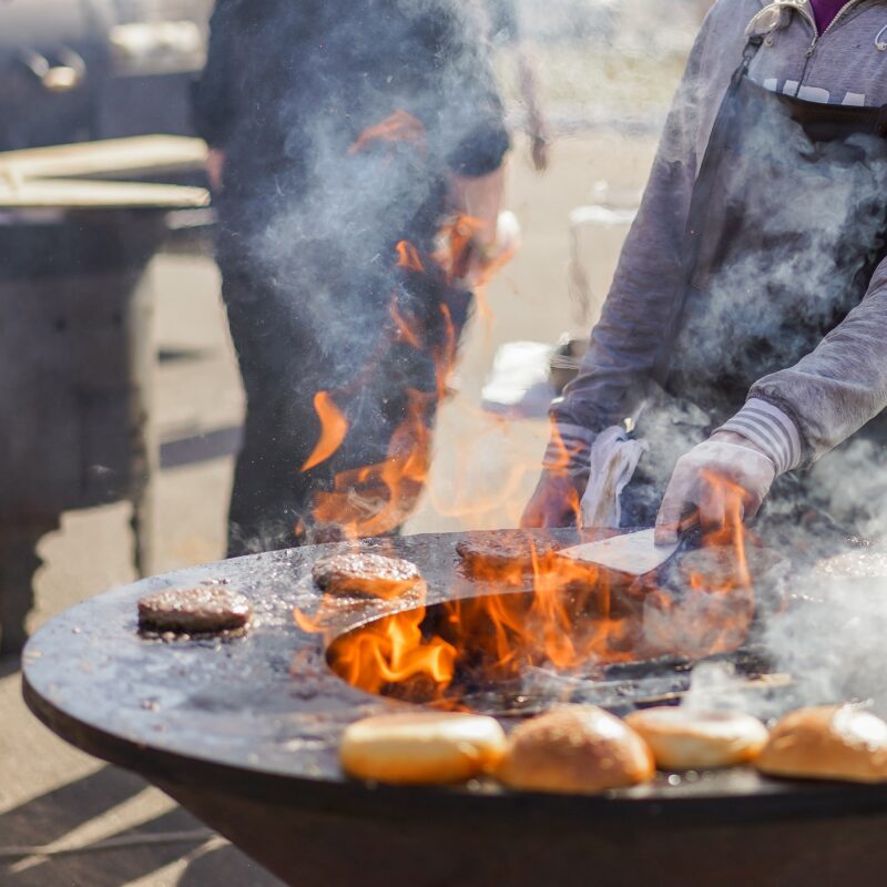 young man cooking burgers on fire 2023 11 27 05 31 58 utc