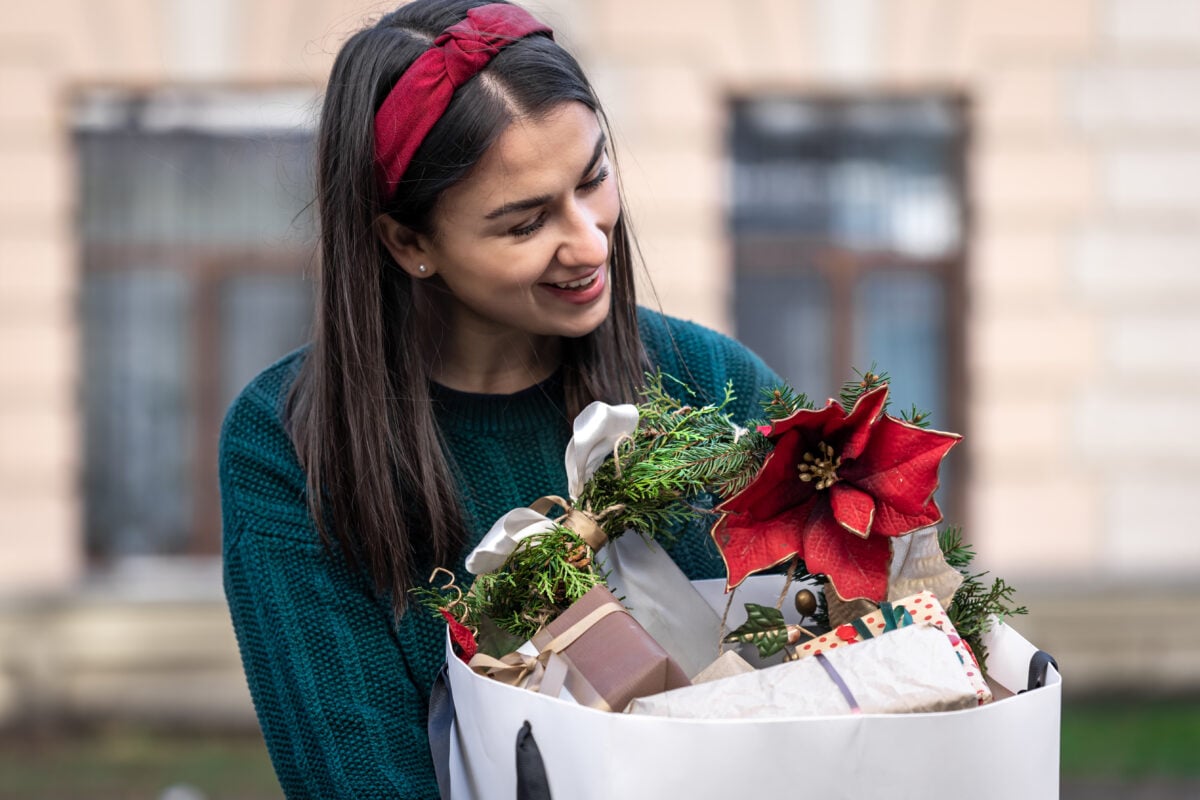 young woman with christmas gifts outside christma 2023 11 27 04 56 41 utc